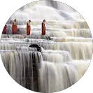Monks standing on waterfall steps
