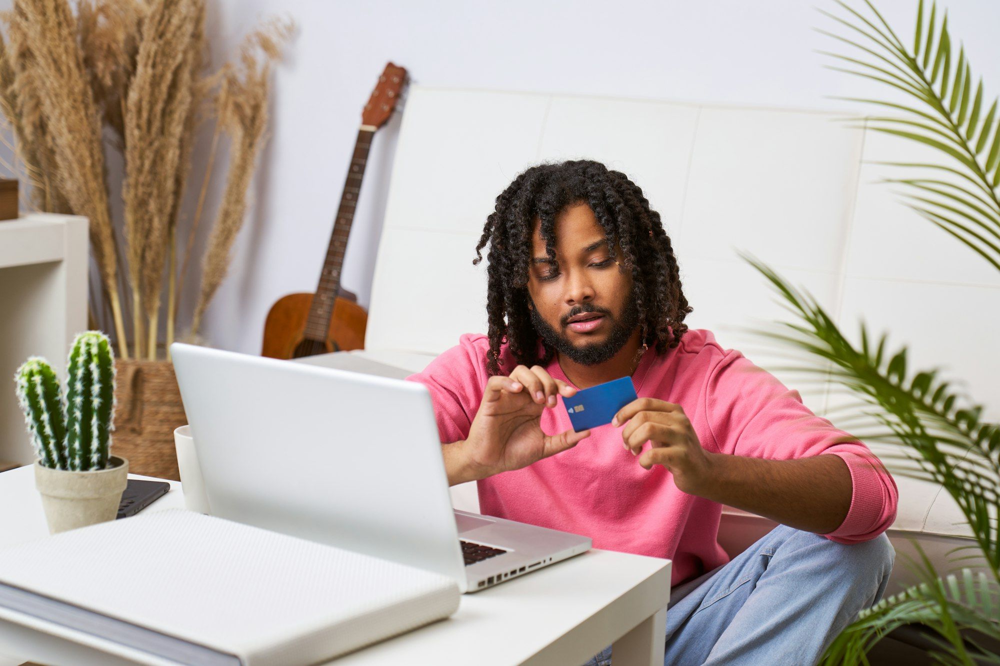 Cheerful young man shopping online satisfied making payment online payment for services